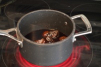 Simmering the dates in wine and honey